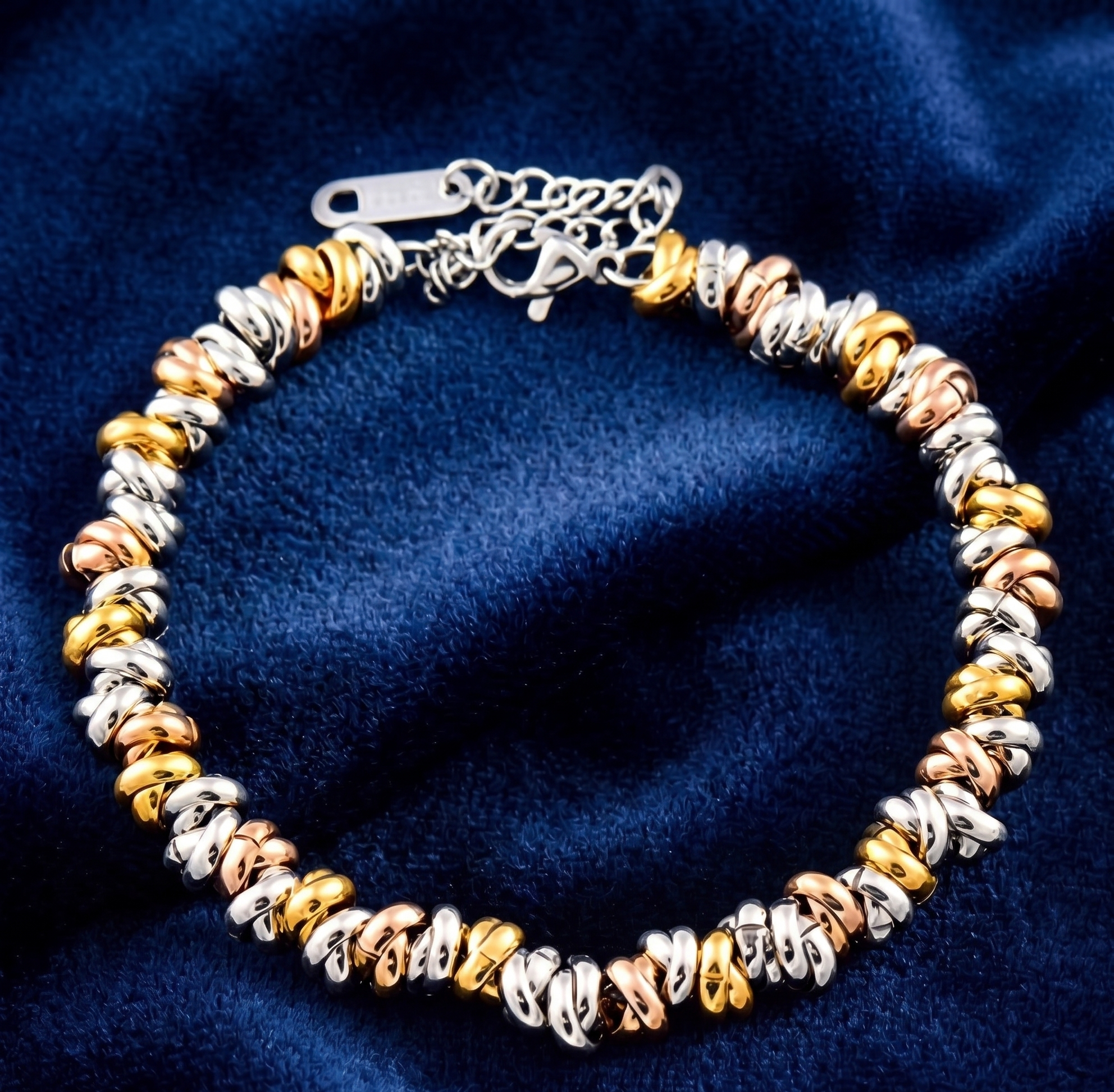 Multicolored beaded bracelet on a blue fabric background