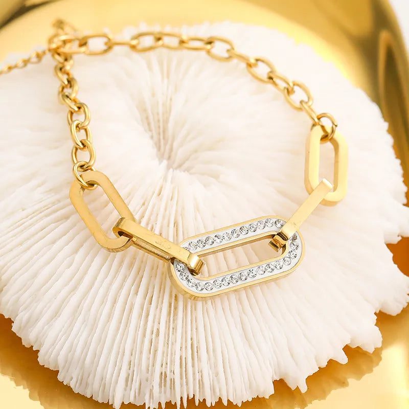 Gold bracelet with a diamond accent on a white fabric background