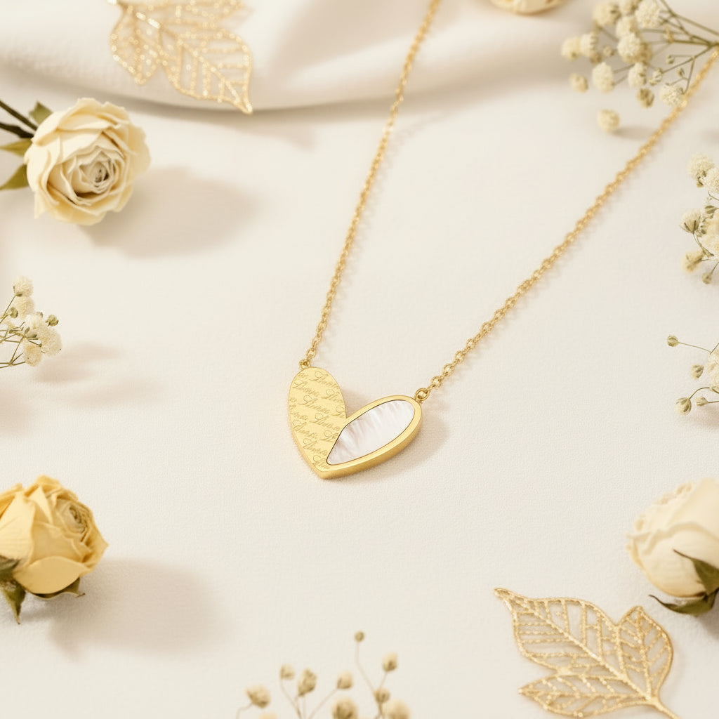 Gold heart-shaped pendant necklace on a soft beige background