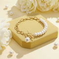 Gold bracelet with pearls on a yellow box with white flowers