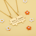 Gold engravable puzzle piece couple necklace set on white background