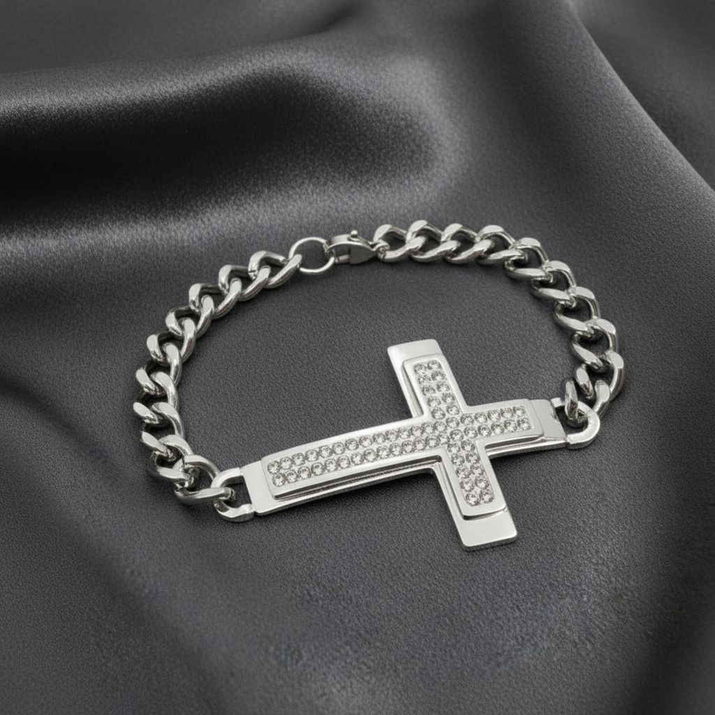 Silver chain bracelet with a cross pendant on a black surface