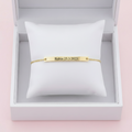 Gold engravable bar bracelet on white background
