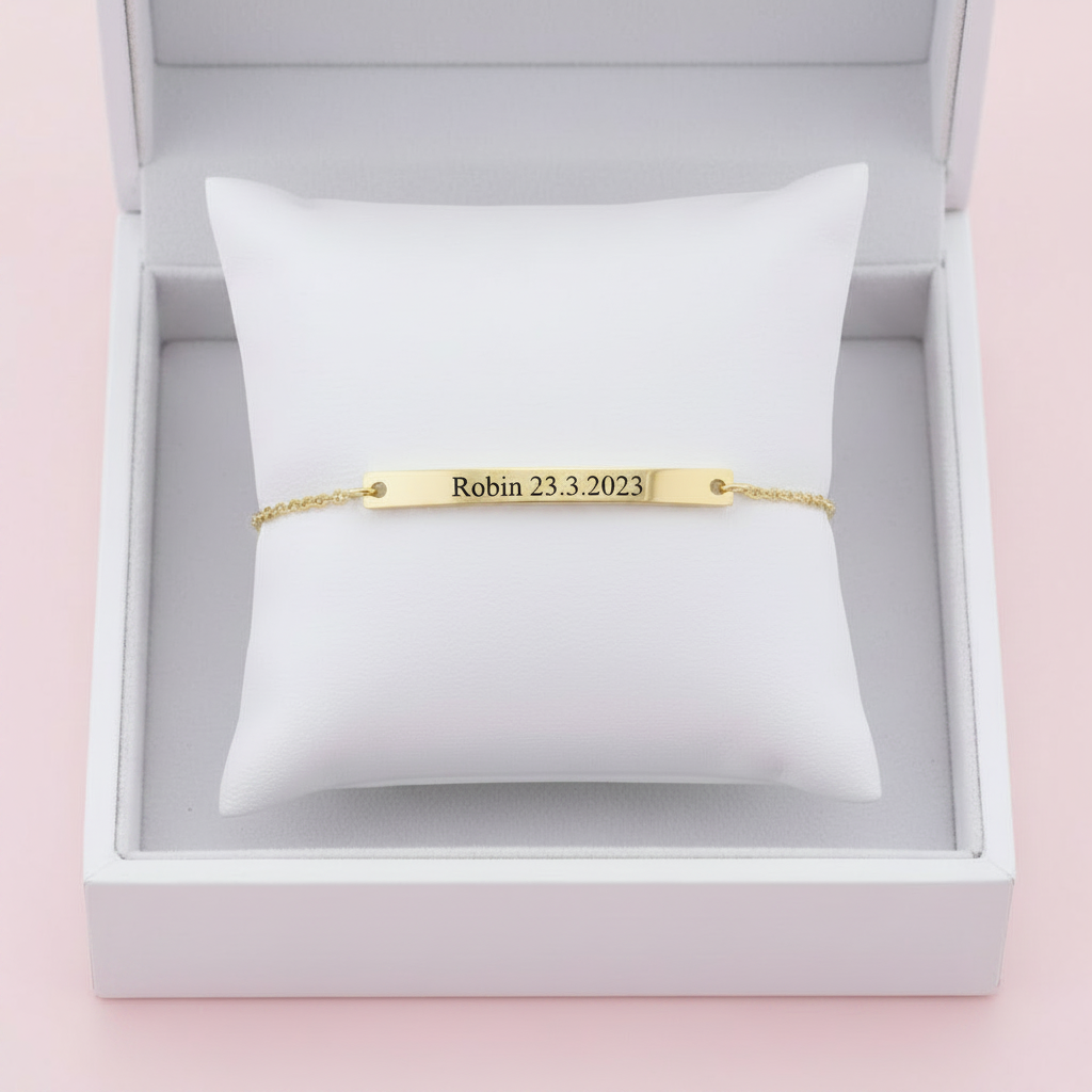 Gold engravable bar bracelet on white background