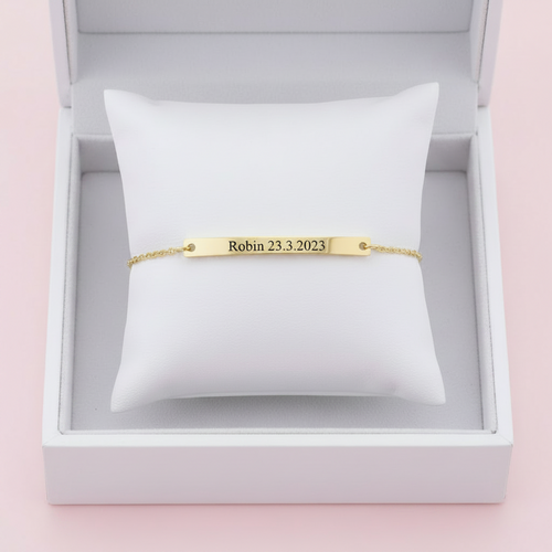 Gold engravable bar bracelet on white background